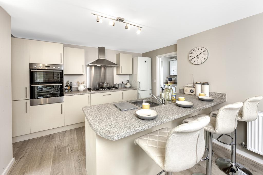 Kitchen with cabinets and island with stools