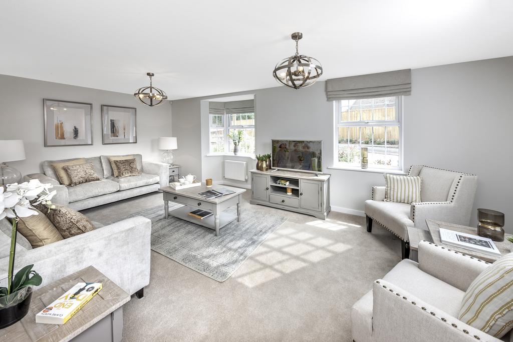 Dual aspect lounge with sofas and chairs and TV