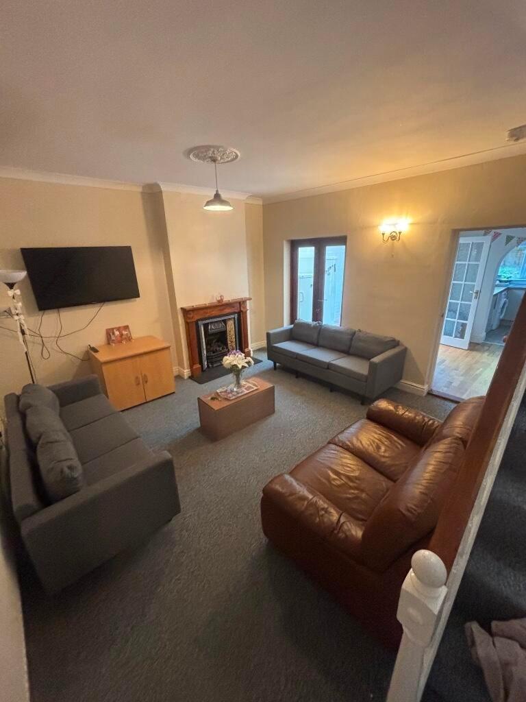 Bright, comfortable living room with two matchi...