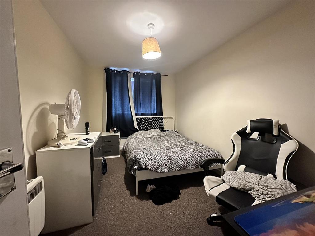 Cozy bedroom with double bed and study setup...