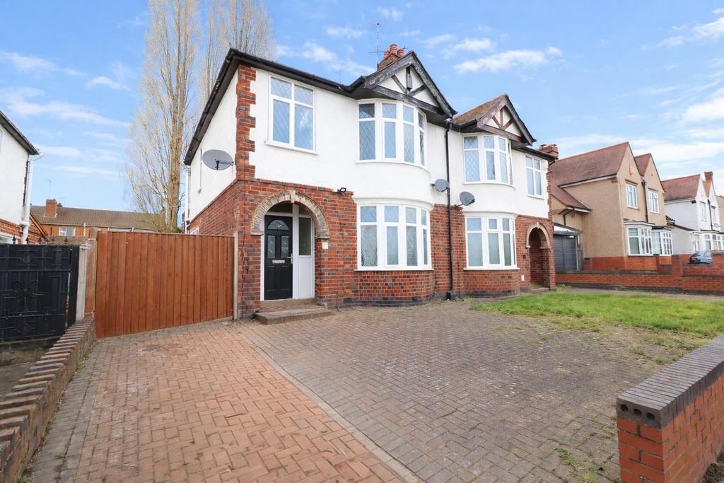 Semi‑detached house with driveway and lawn...