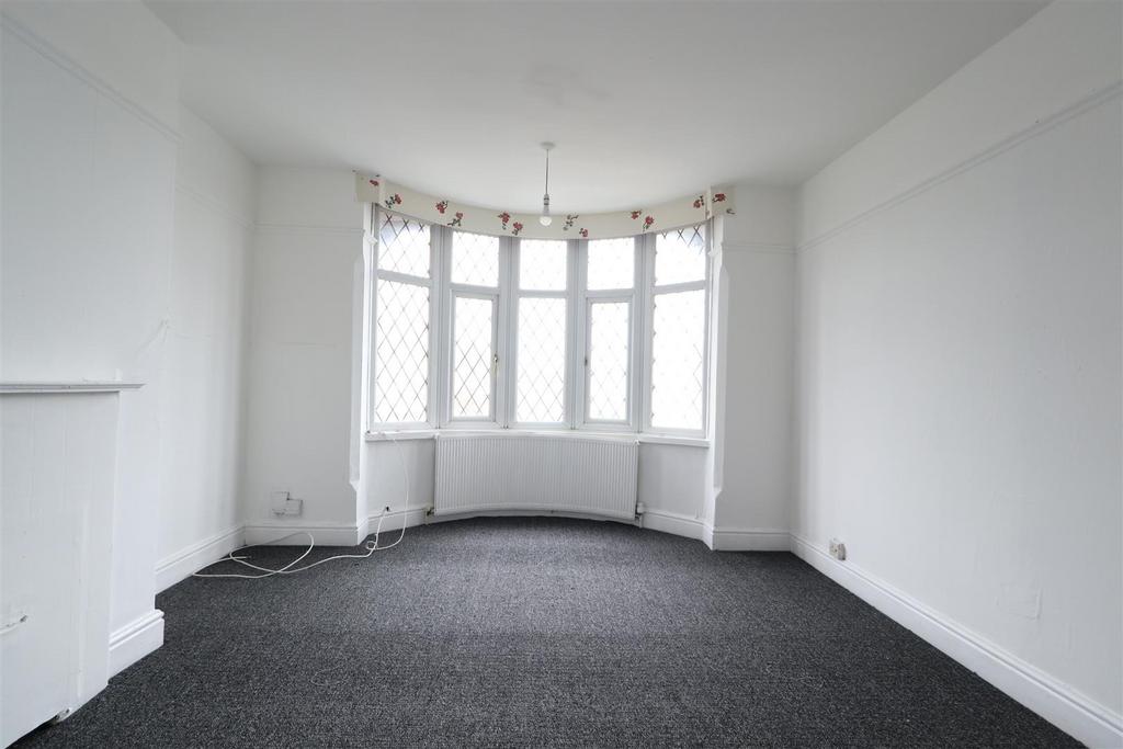 Bright living room with large bay window...