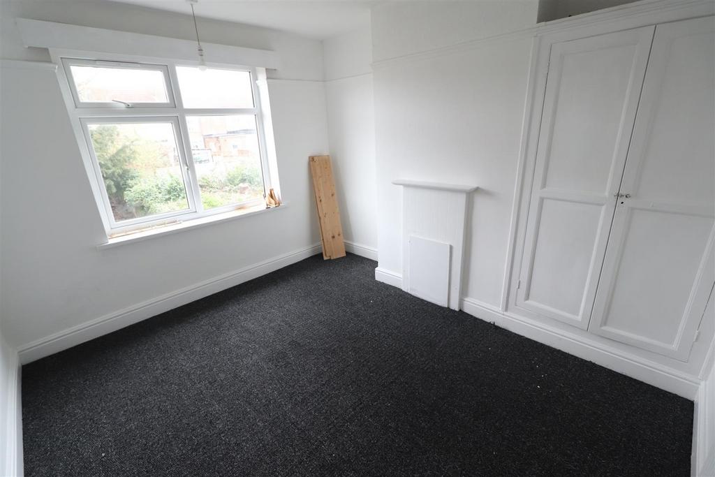 Bright bedroom with built‑in wardrobe and large...