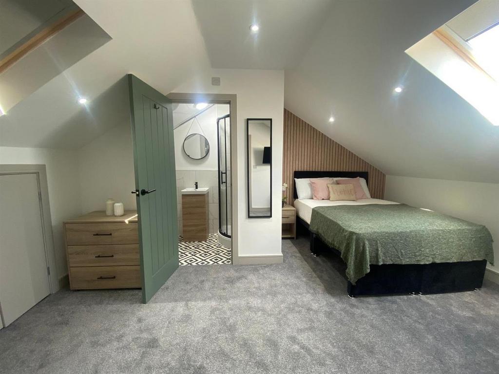 Bright, modern attic bedroom with a comfortable...