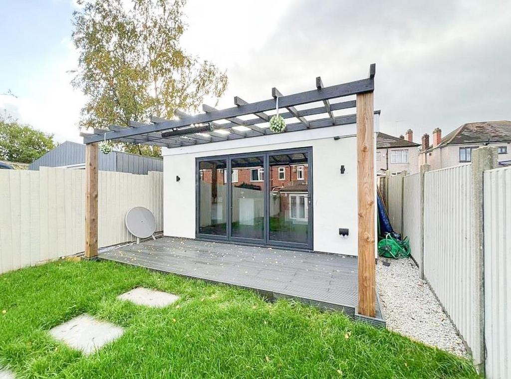 Private rear garden with covered patio and lawn...