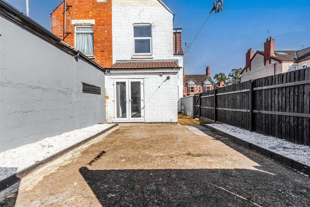 Sunny paved rear yard with private gated access...