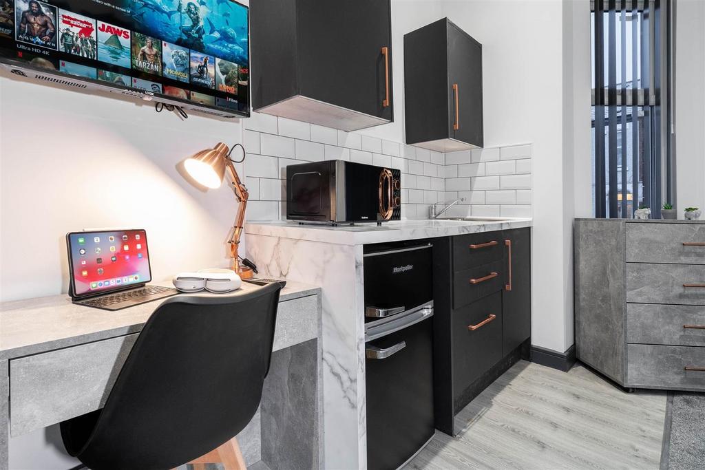 Modern compact kitchenette with built-in oven, ...