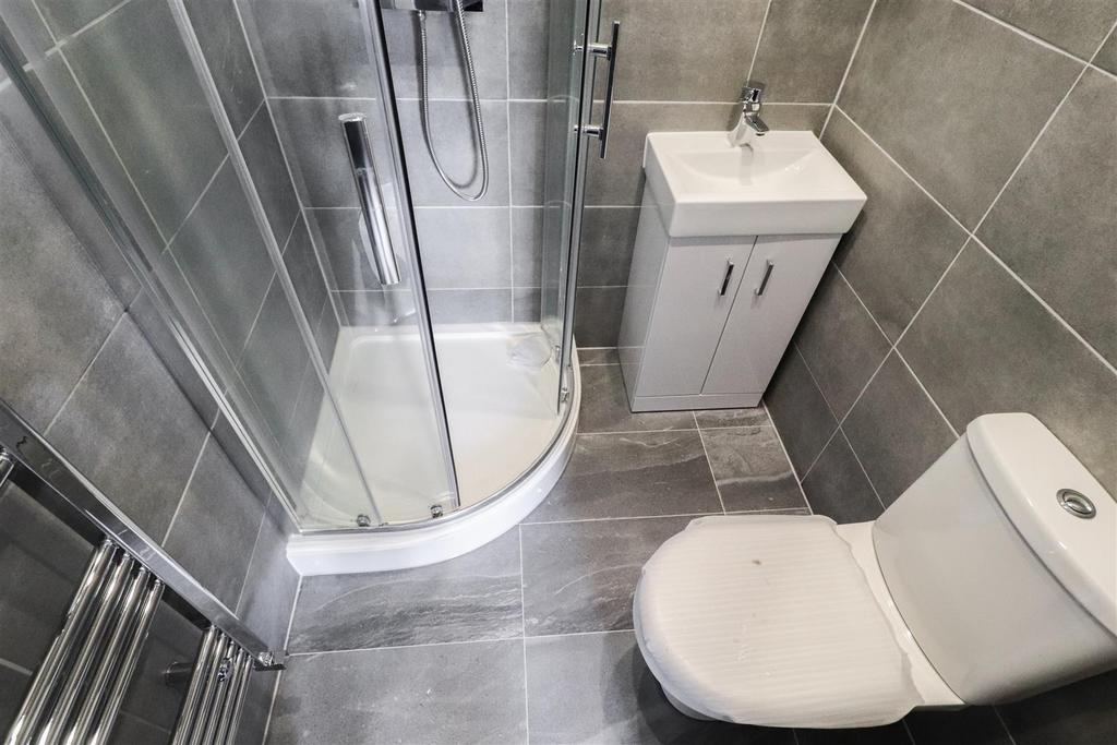 Modern tiled bathroom with shower and vanity...