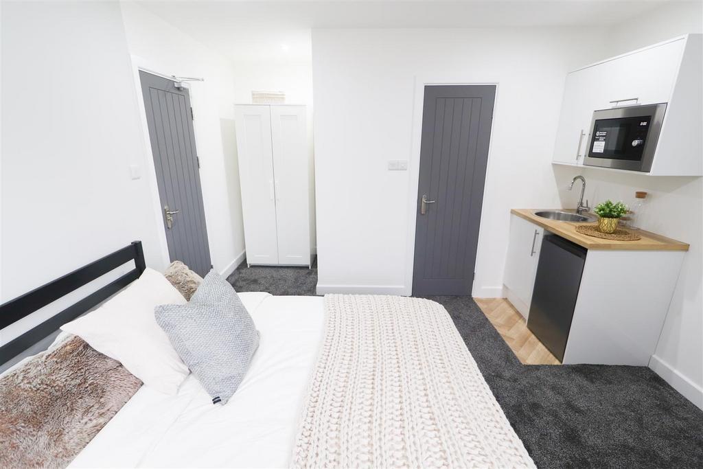 Bright bedroom with fitted kitchenette and stor...