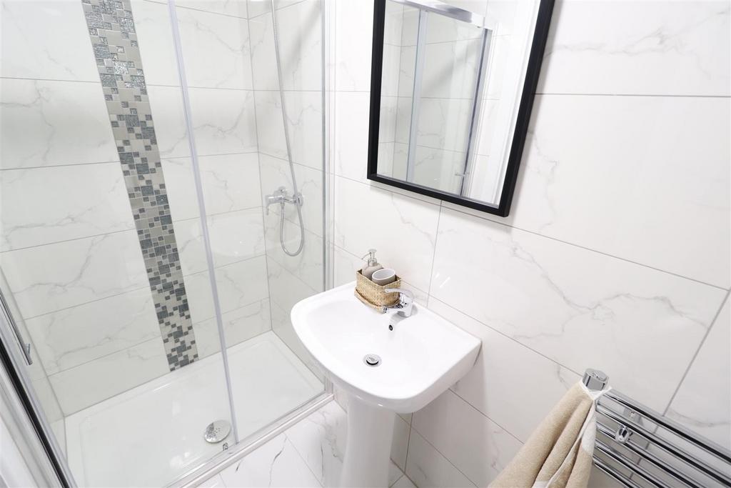 Bright modern bathroom with walk-in shower...