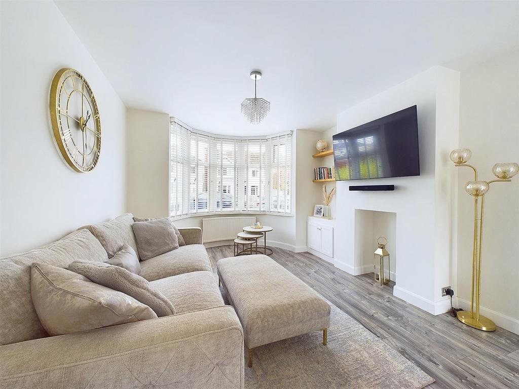 Bright, modern living room with a large bay win...