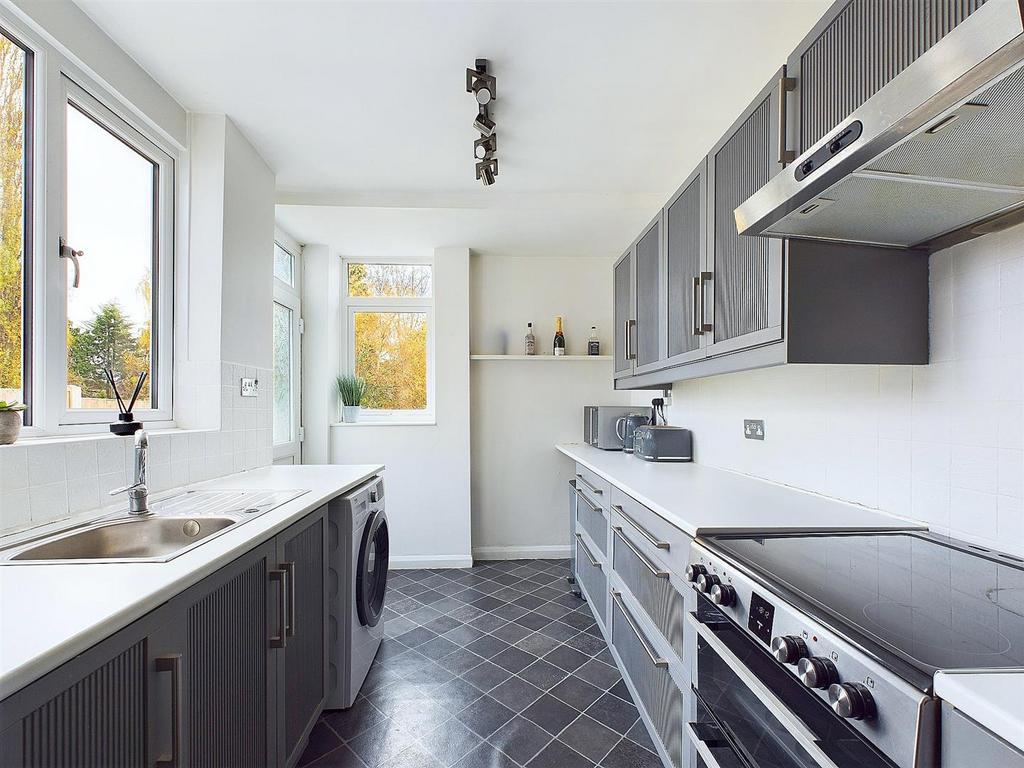 Bright, modern galley kitchen with large window...