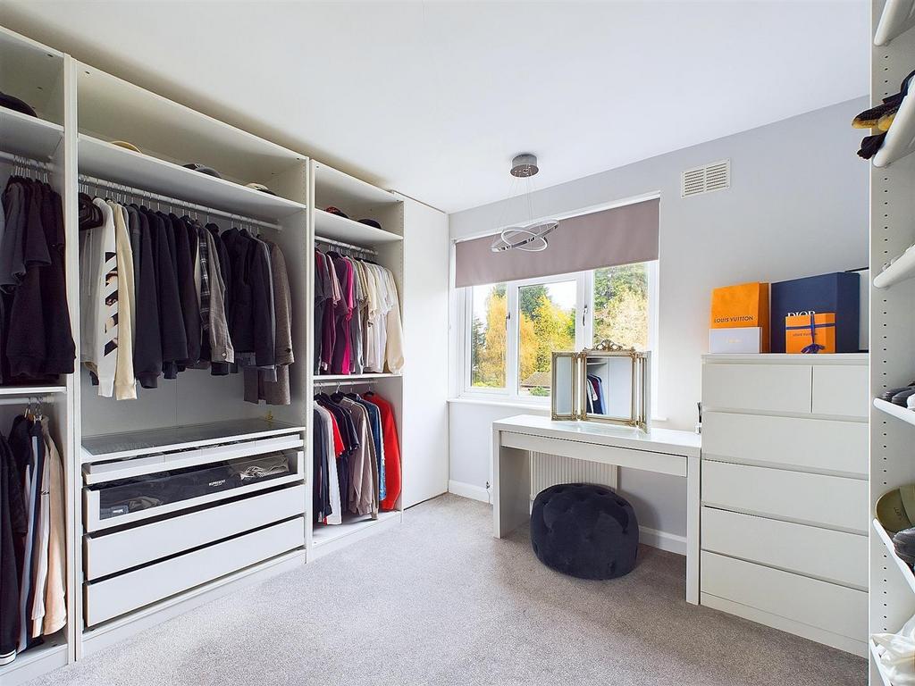 Bright bedroom with built-in wardrobe and desk...