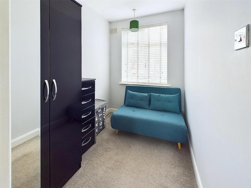 Bright, simply furnished single bedroom with a ...