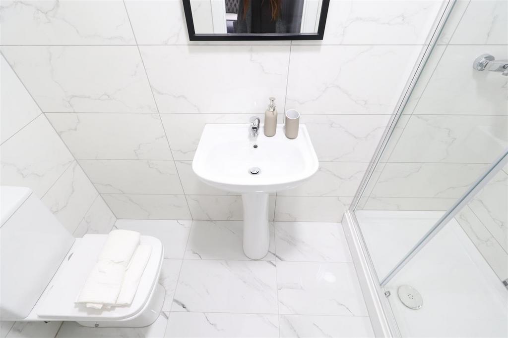 Bright modern white bathroom with shower...
