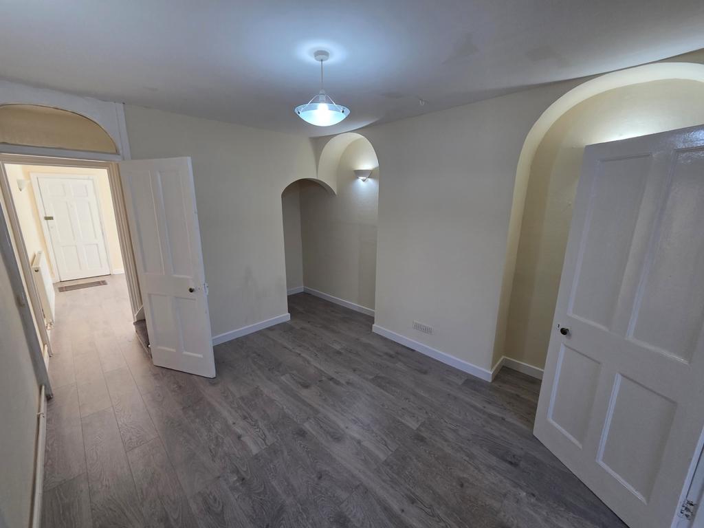 Bright bedroom with modern flooring and arched ...