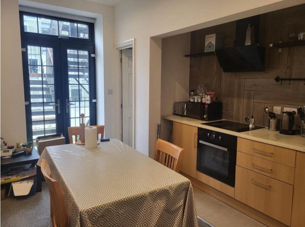 Well-lit kitchen-diner with modern units...