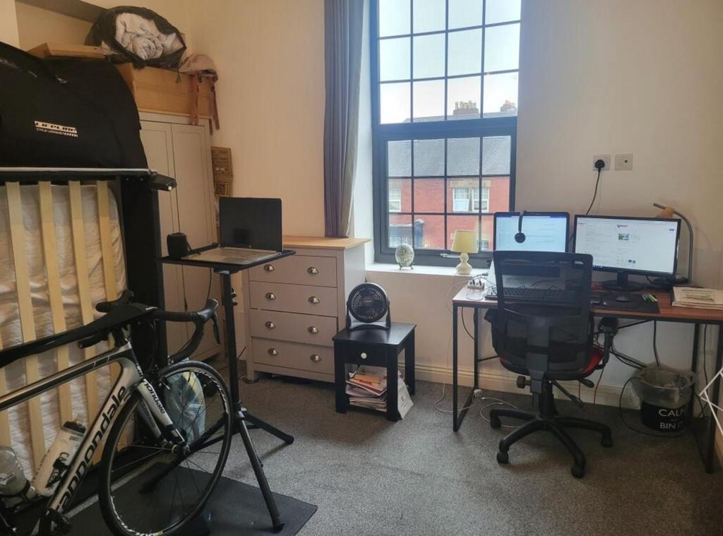 Bright bedroom with study desk and large window...