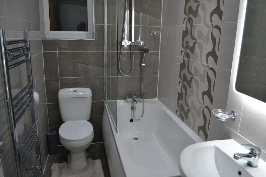 Modern bathroom featuring a combined shower and...