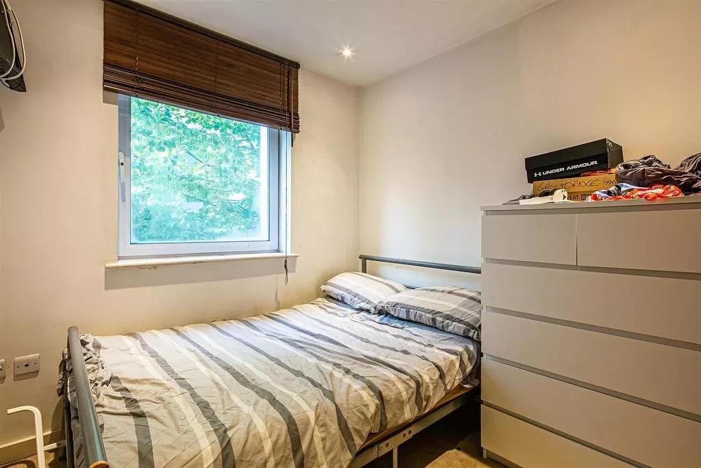 Cozy double bedroom featuring a comfortable bed...