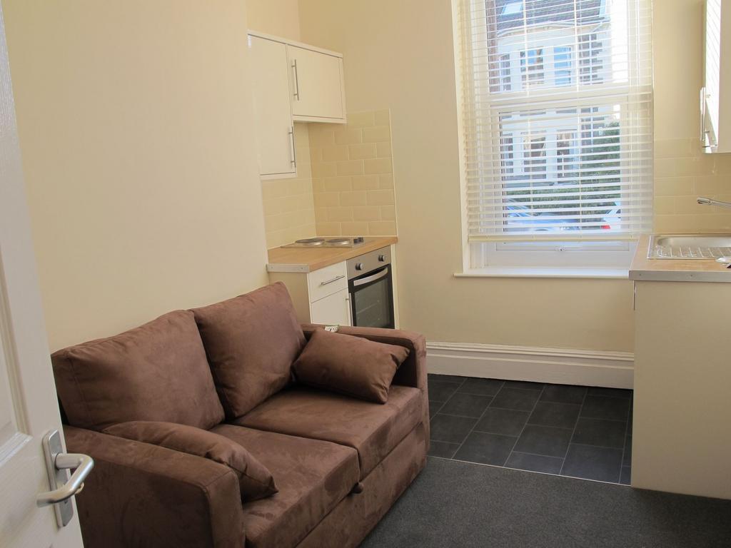 Compact living area with sofa and natural light...