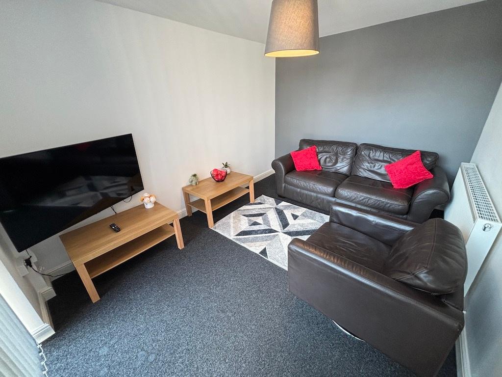 Bright, modern living room with a leather sofa ...