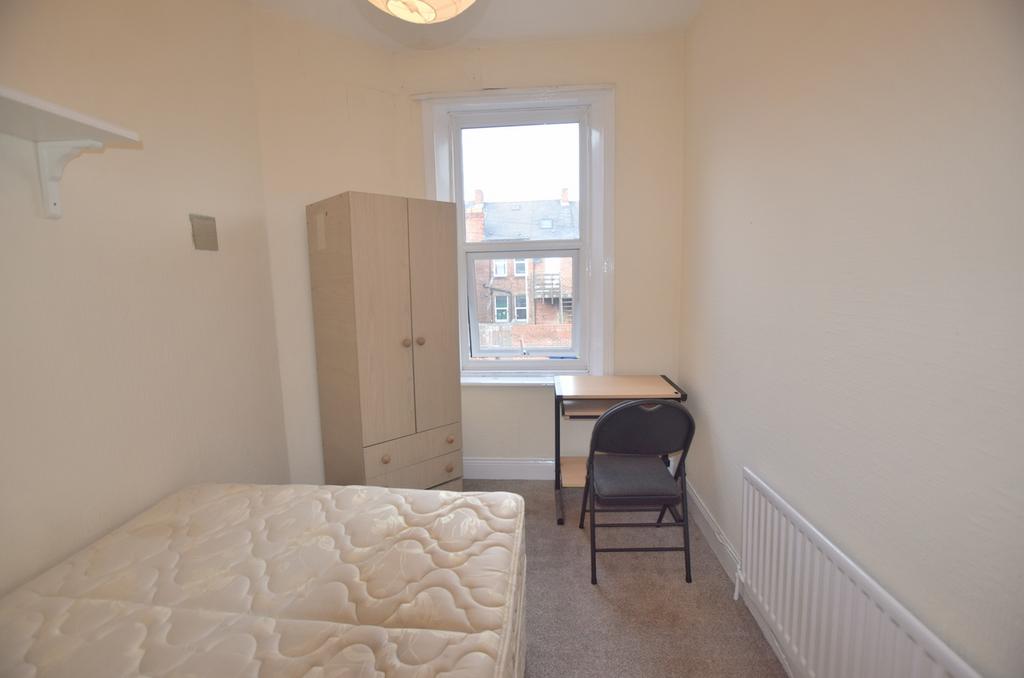 Cozy double bedroom featuring ample natural lig...