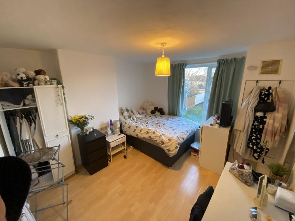 Bright, well-kept bedroom with a double bed by ...