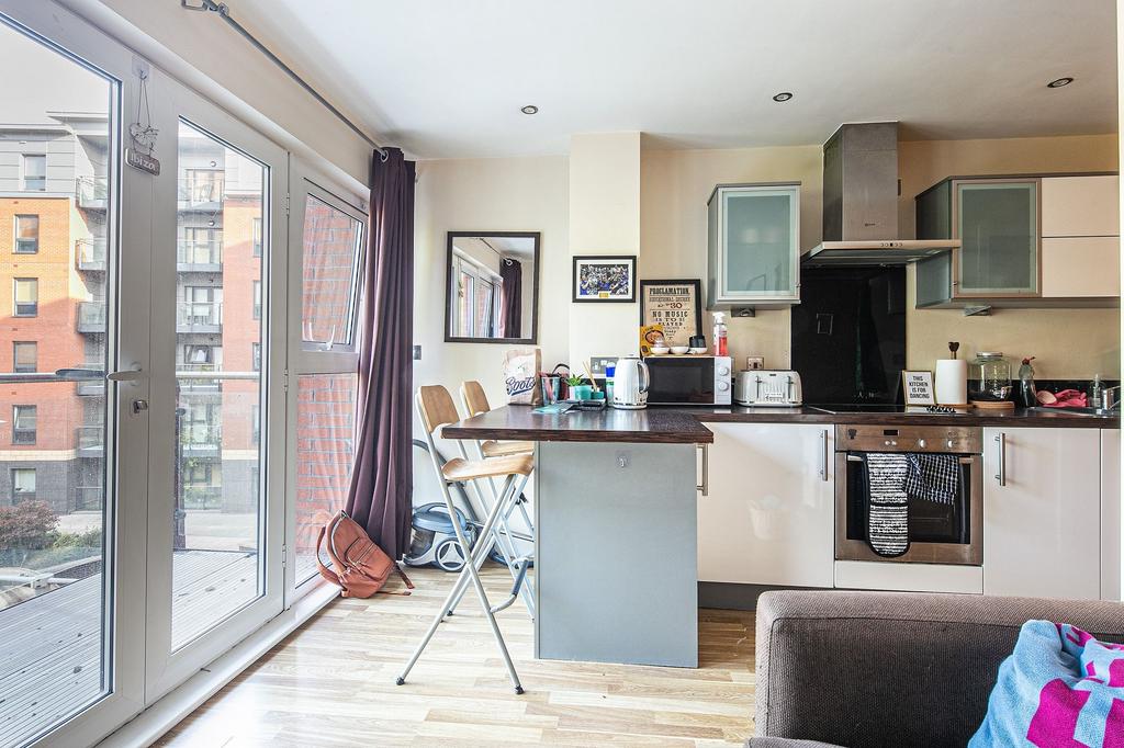 Bright modern open-plan kitchen with full-heigh...