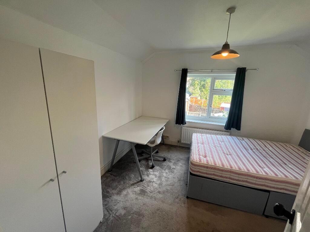 Bright, neatly presented bedroom with a comfort...