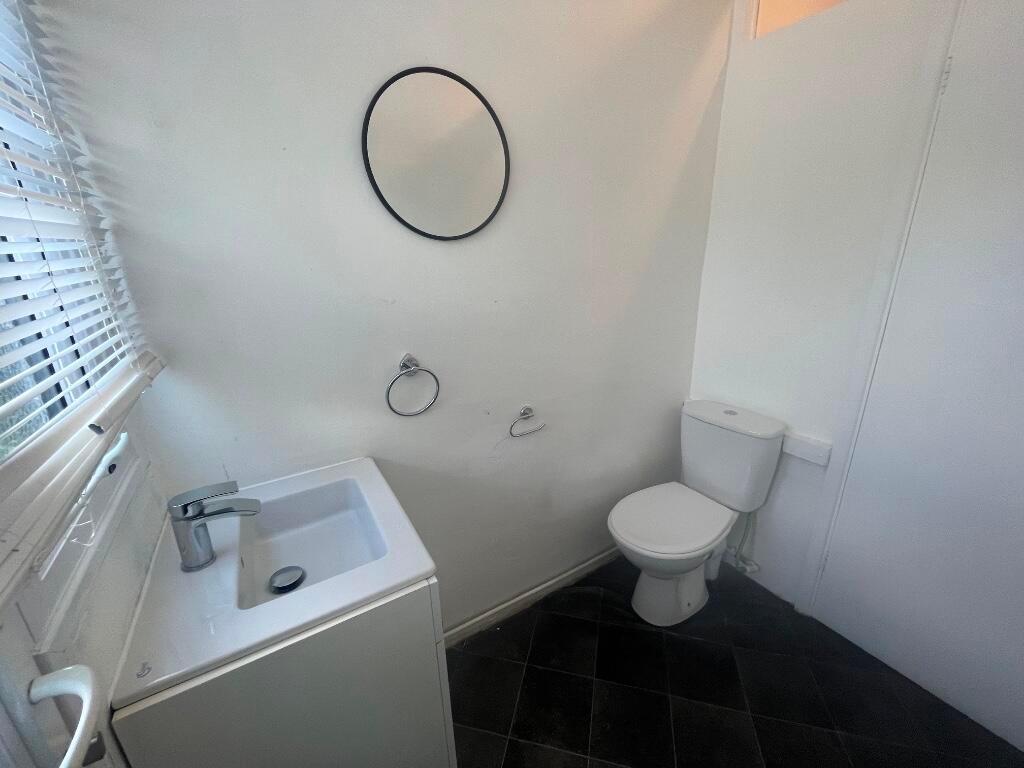 Compact white bathroom with a modern basin and ...