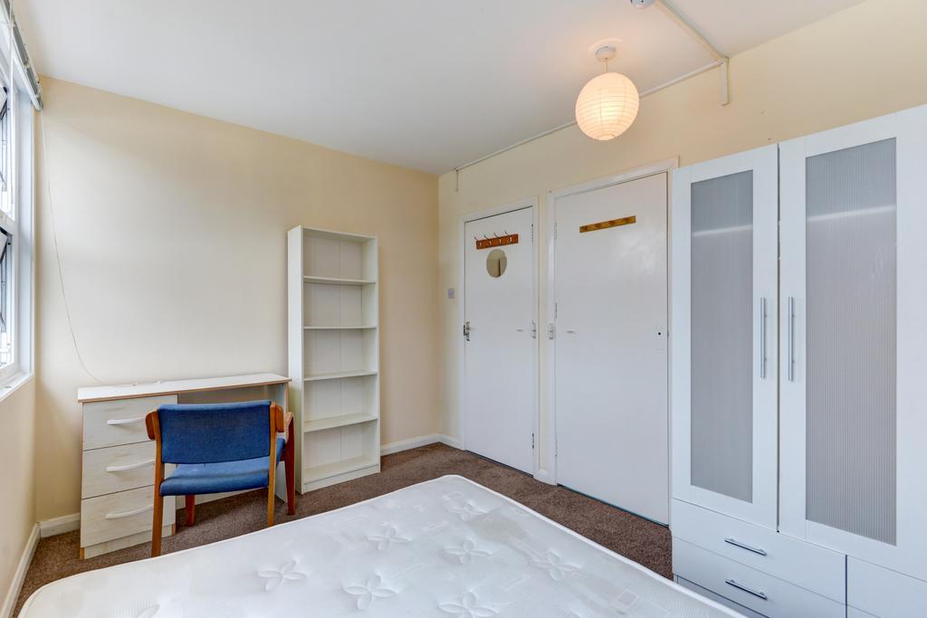 Bright, neatly presented bedroom with a large w...