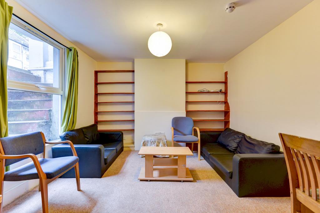 Bright communal living room with comfortable so...