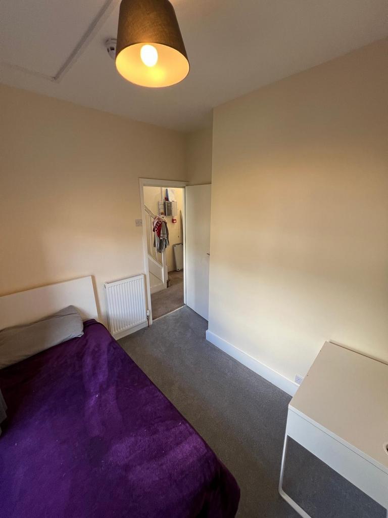 A tidy and cozy master bedroom featuring a comf...