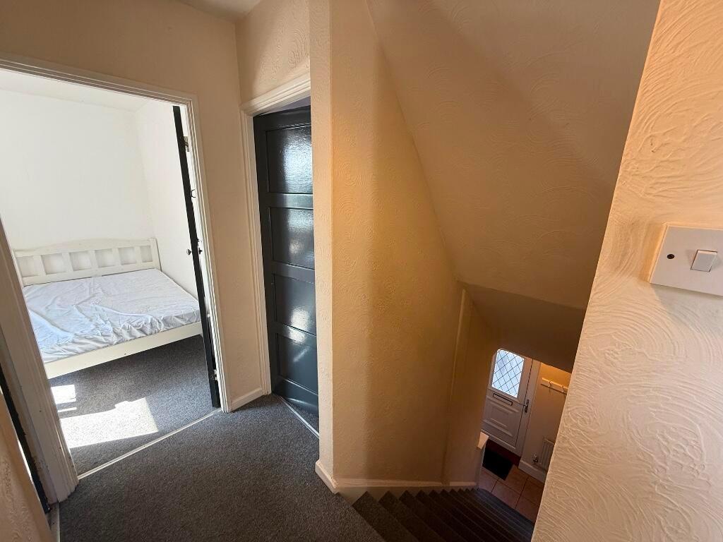 Bright first-floor landing with carpeted stairs...