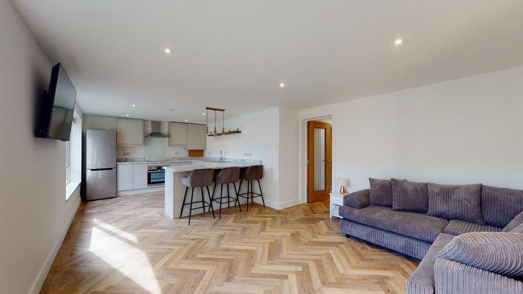 Bright open-plan living area with a modern kitc...
