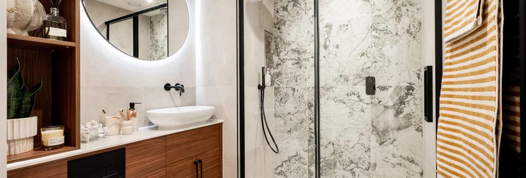 Modern designed bathroom with shower unit, wash...