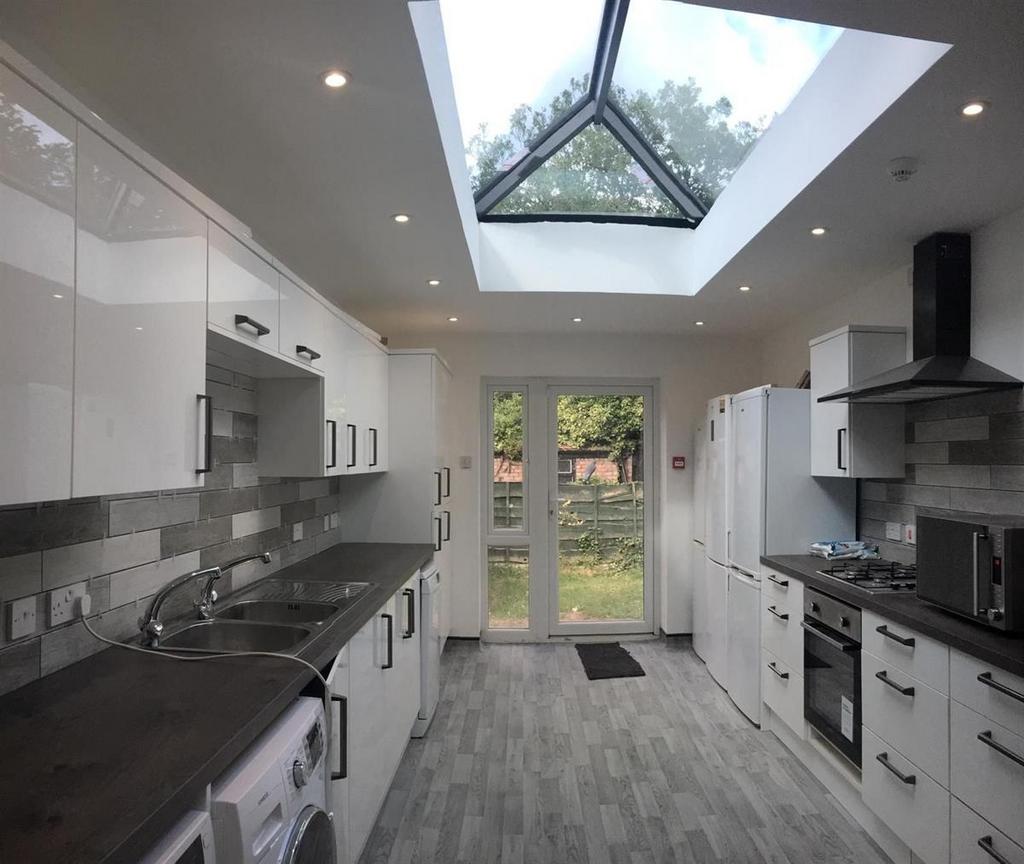 Bright modern kitchen with skylight and garden...