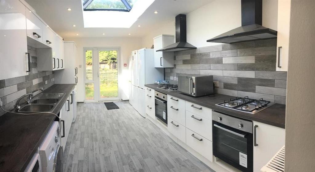 Bright modern galley kitchen with garden access...