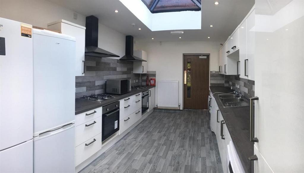 Bright modern galley kitchen with skylight...