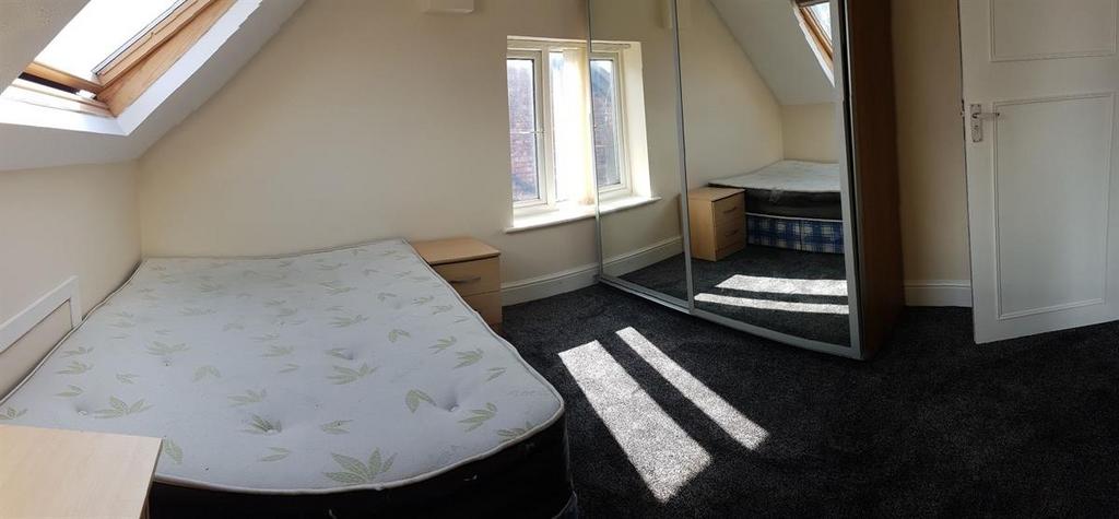 Bright attic double bedroom with built-in wardr...