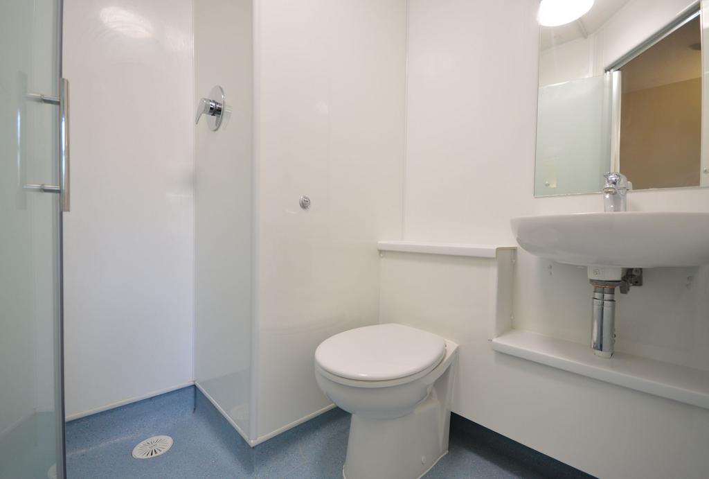 Compact modern bathroom with shower and sink...