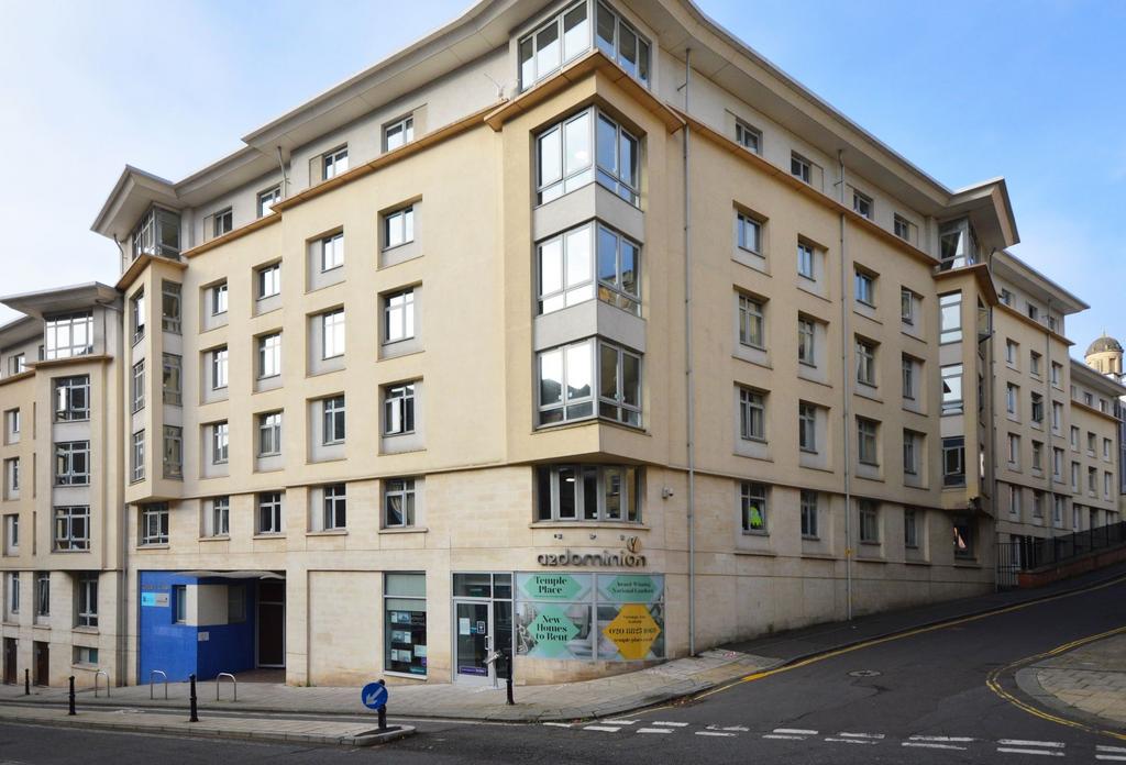 Modern corner apartment building on a sloped ci...