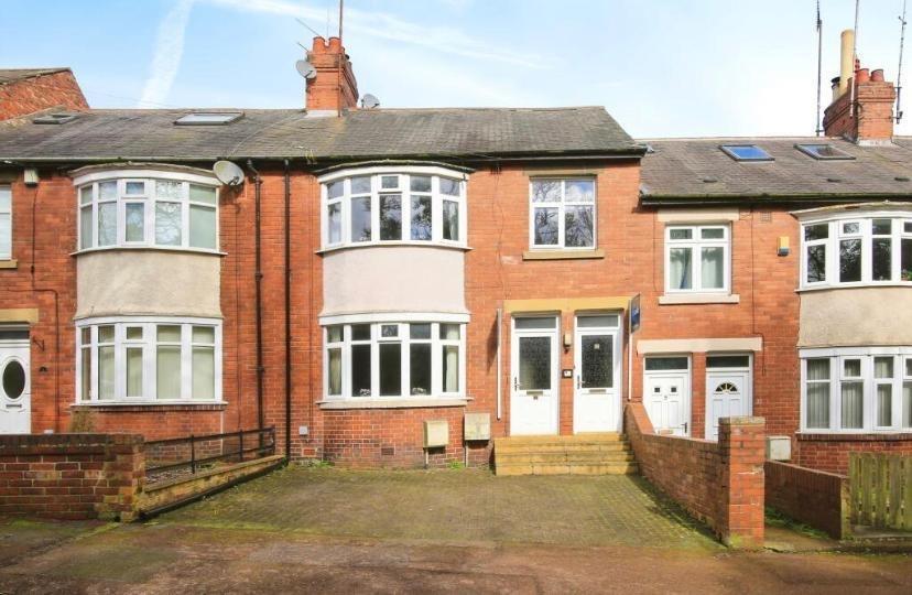 Well-maintained red-brick terraced house with a...