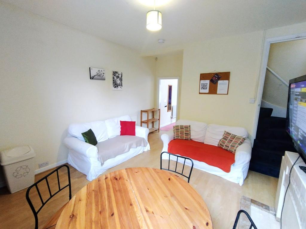 Bright, neutrally decorated living room with tw...