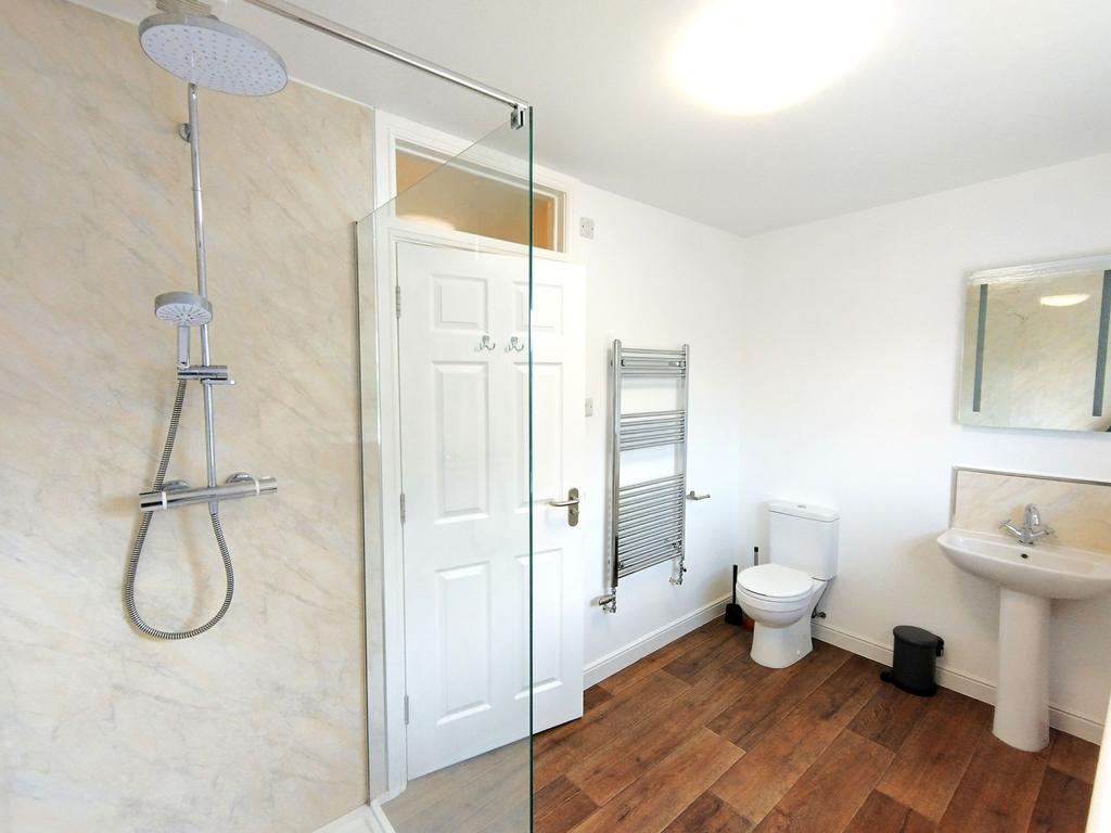 Bright, modern bathroom with a walk-in shower, ...