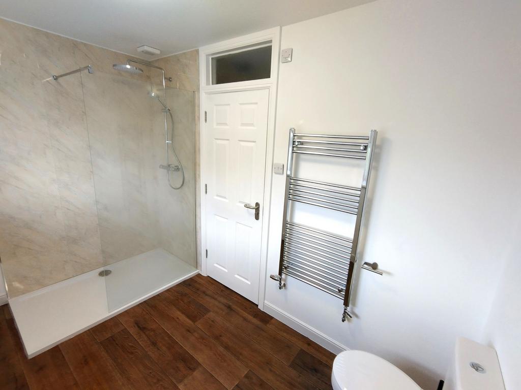 Bright modern bathroom with a large walk-in sho...