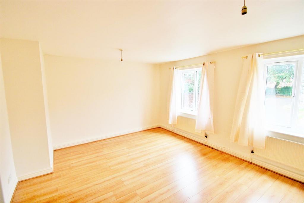 A bright and airy living room with large window...