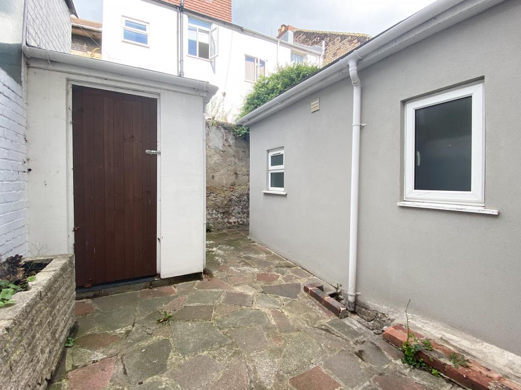 Private paved yard with stone flagging, outbuil...