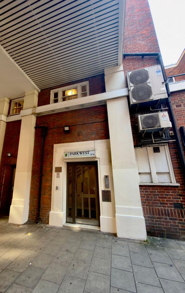 Attractive secure building entrance with covere...
